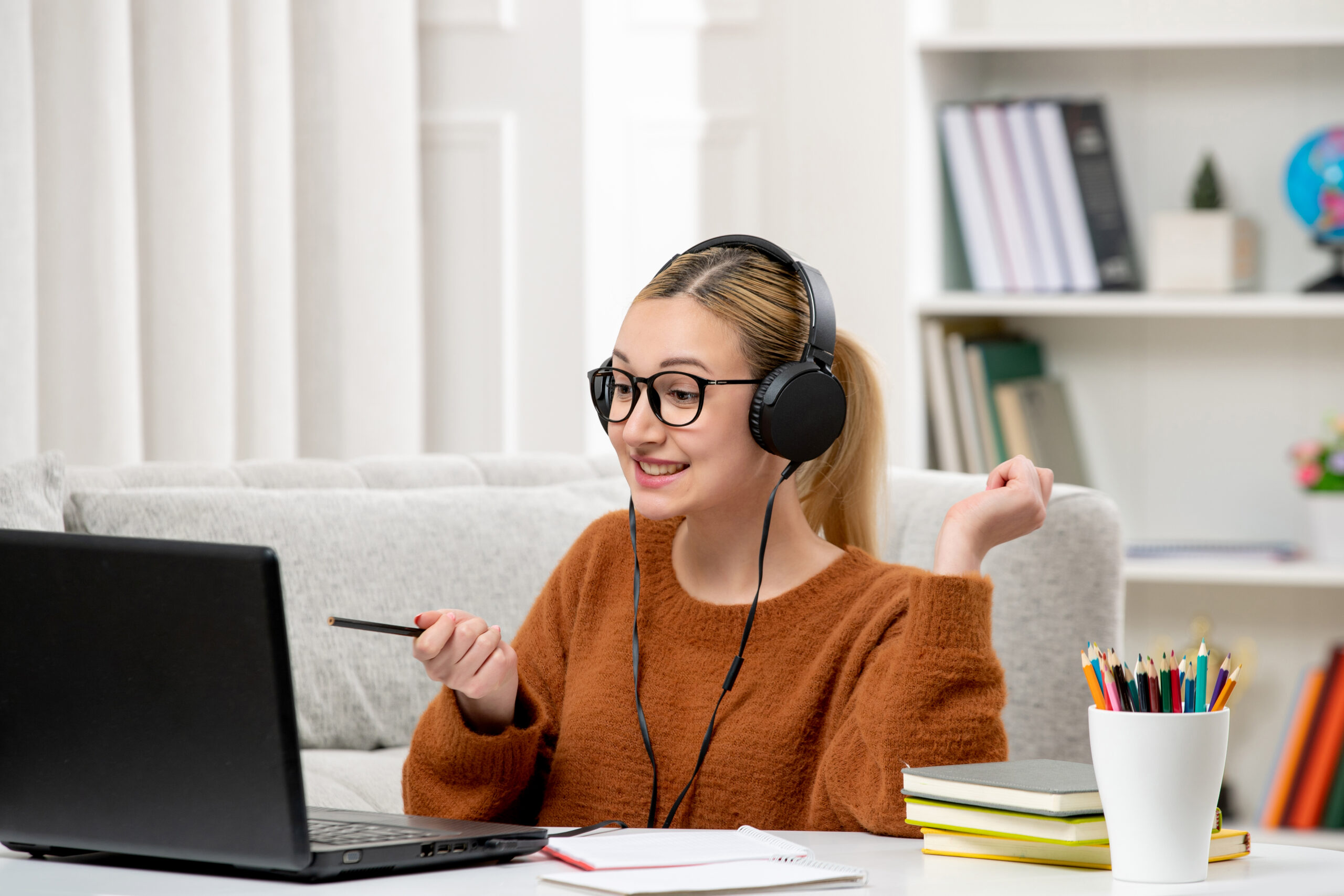 student online cute girl glasses sweater studying computer smiling happily