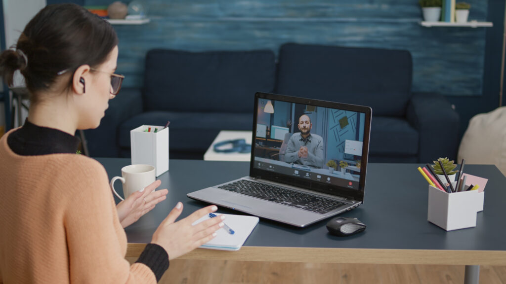 young woman meeting with teacher on remote video call